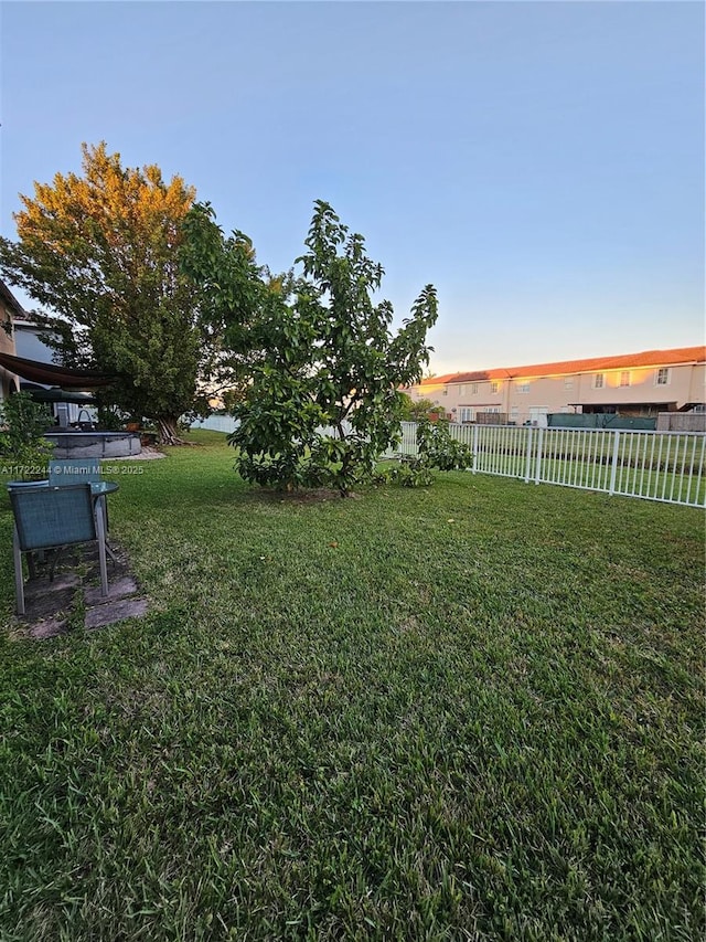 view of yard at dusk