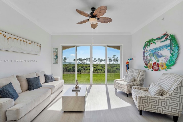 living room with ceiling fan, wood-type flooring, and ornamental molding