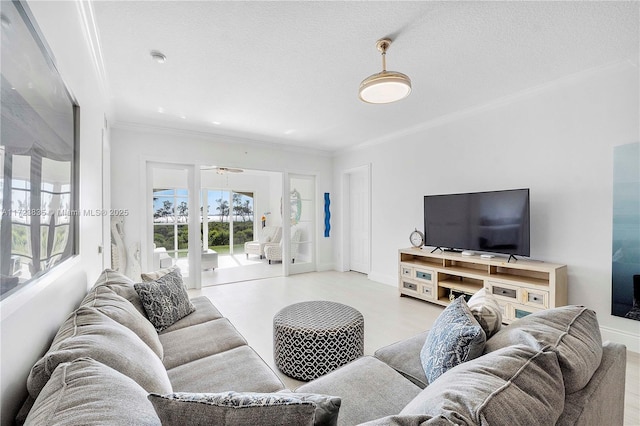 living room featuring ceiling fan, crown molding, and a textured ceiling