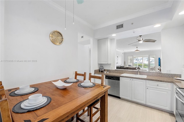 kitchen featuring white cabinetry, sink, ceiling fan, stainless steel dishwasher, and crown molding