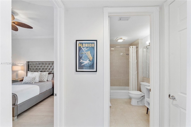 bedroom featuring ceiling fan and connected bathroom