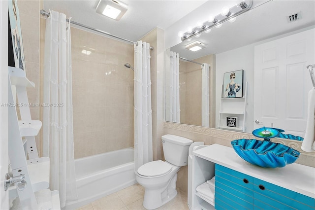 full bathroom with shower / bath combo, tile patterned floors, a textured ceiling, toilet, and vanity