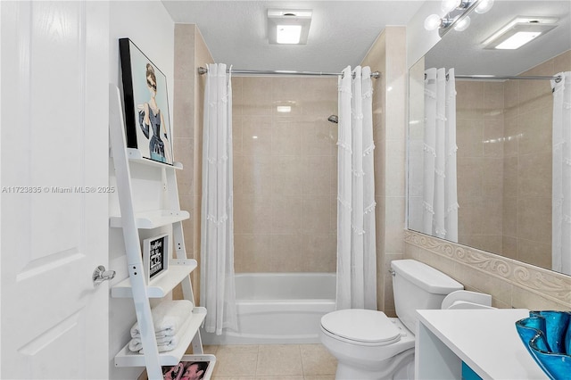 full bathroom with tile patterned floors, a textured ceiling, toilet, shower / bath combo with shower curtain, and vanity