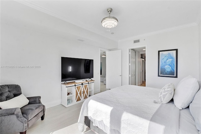 bedroom featuring crown molding and light wood-type flooring