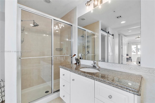 bathroom featuring vanity and a shower with shower door