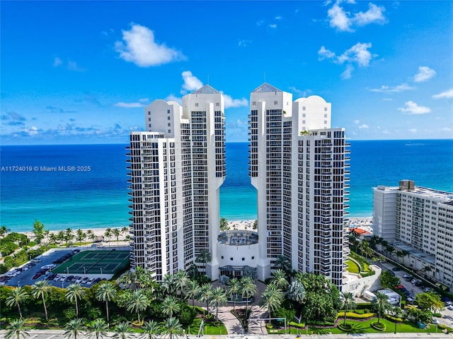 view of property featuring a water view and a view of the beach