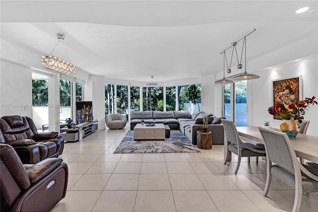 living room featuring light tile patterned floors and a chandelier