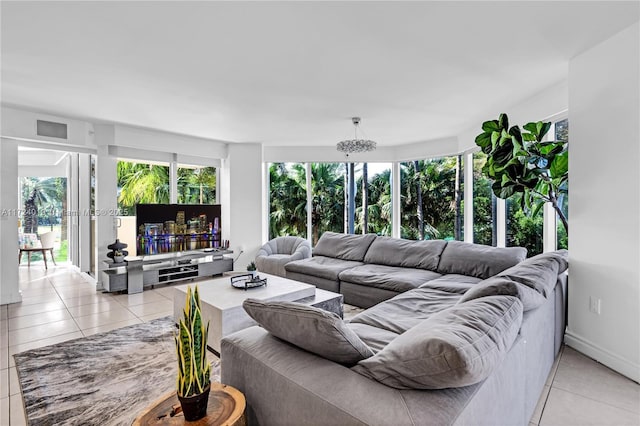 tiled living room featuring a chandelier