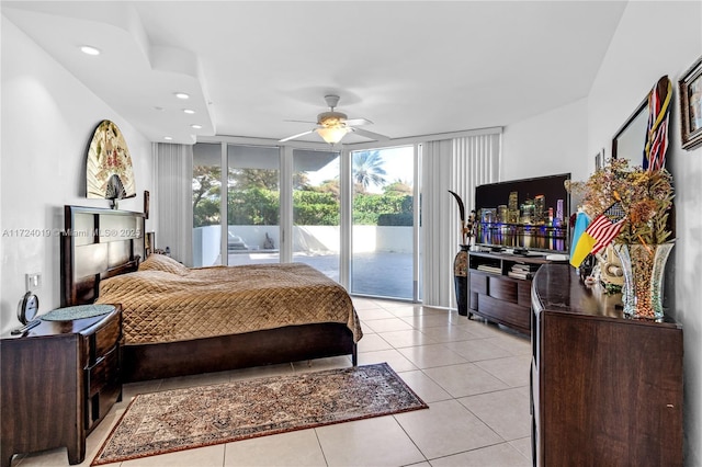 tiled bedroom featuring access to outside, a wall of windows, and ceiling fan