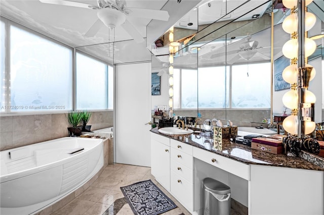 bathroom featuring ceiling fan, vanity, and a bathing tub