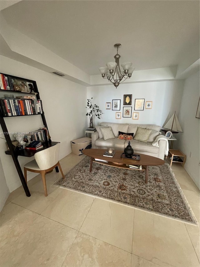 tiled living room featuring a chandelier and a tray ceiling