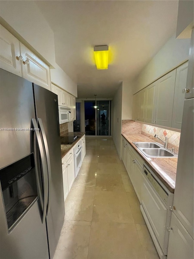 kitchen with white cabinets, white appliances, tasteful backsplash, and sink