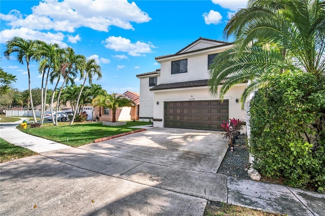 view of front of house featuring a garage and a front lawn