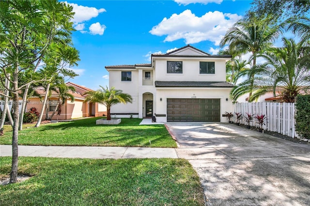 mediterranean / spanish-style house featuring a garage and a front lawn