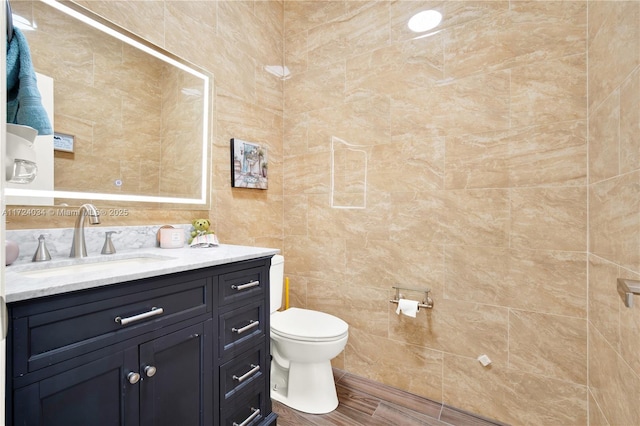 bathroom featuring hardwood / wood-style floors, vanity, and toilet