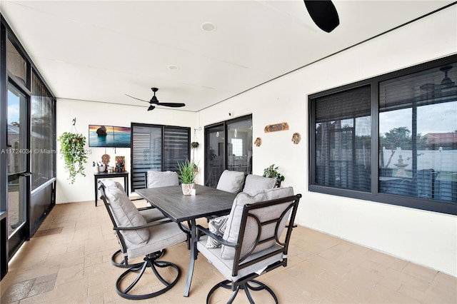 sunroom featuring ceiling fan