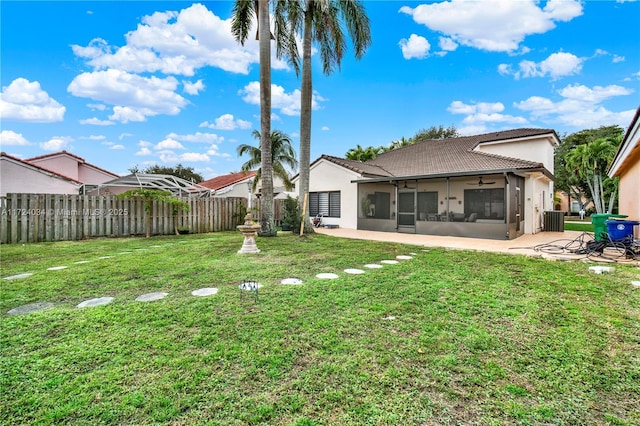 back of house featuring a patio, cooling unit, a lawn, and a sunroom