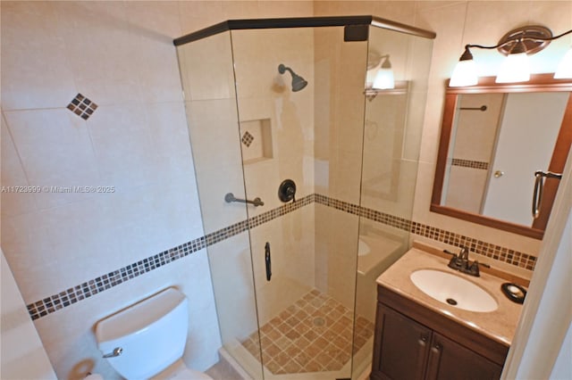 bathroom with vanity, tasteful backsplash, toilet, and an enclosed shower