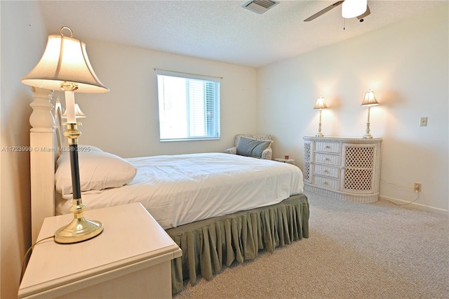 bedroom with carpet, ceiling fan, and a textured ceiling