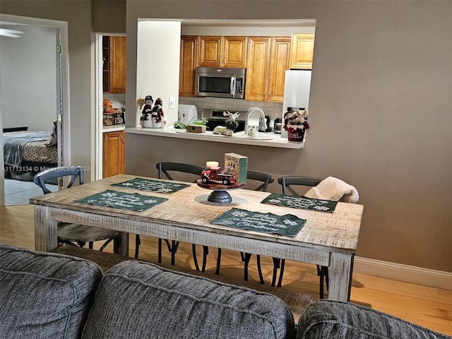 kitchen featuring backsplash, hardwood / wood-style floors, and stainless steel appliances