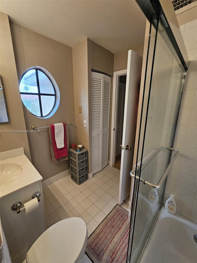 full bathroom with tile patterned flooring, vanity, toilet, and bath / shower combo with glass door