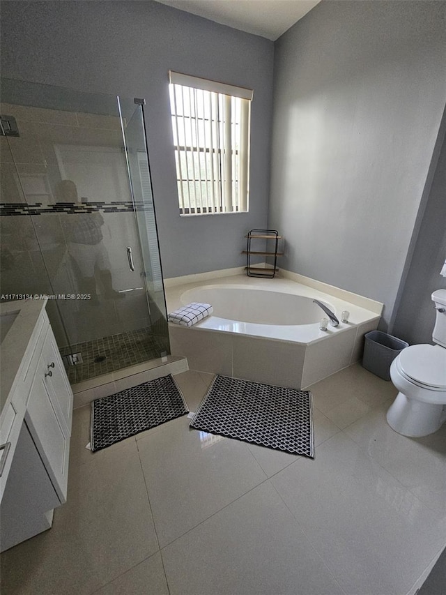 full bathroom with tile patterned flooring, vanity, separate shower and tub, and toilet