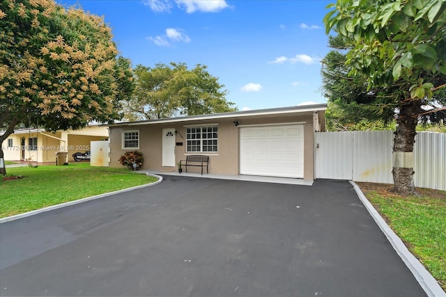 ranch-style house with a garage and a front lawn