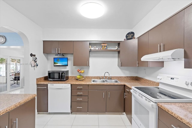 kitchen with sink, light tile patterned floors, and white appliances