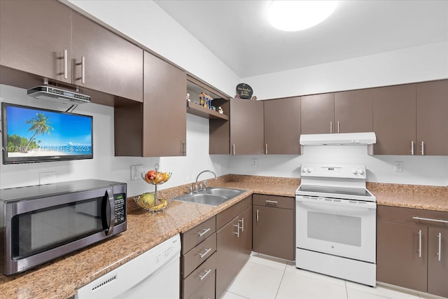 kitchen with sink, light tile patterned floors, and white appliances