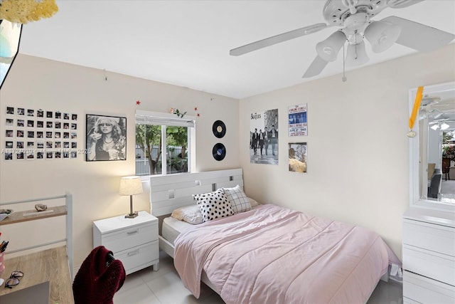 tiled bedroom featuring ceiling fan