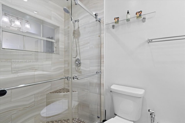 bathroom featuring toilet and walk in shower