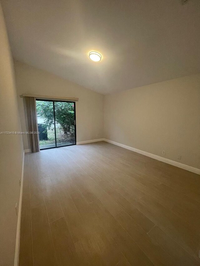 spare room featuring vaulted ceiling