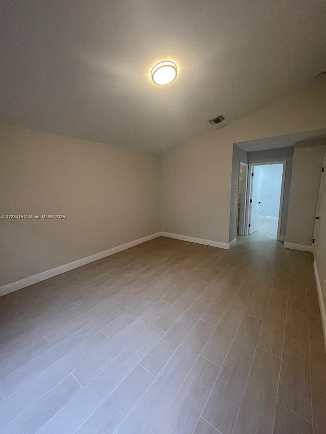 spare room with vaulted ceiling