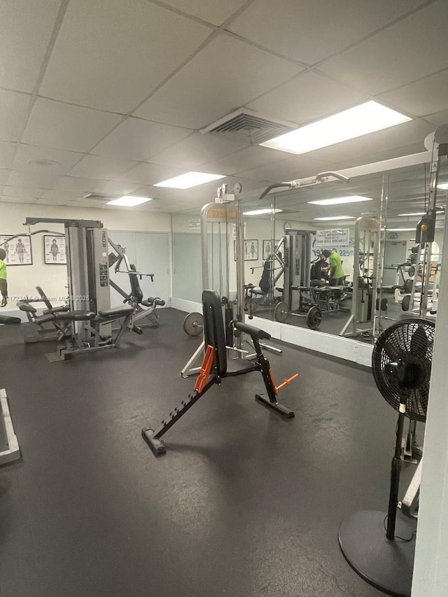 exercise room with a paneled ceiling