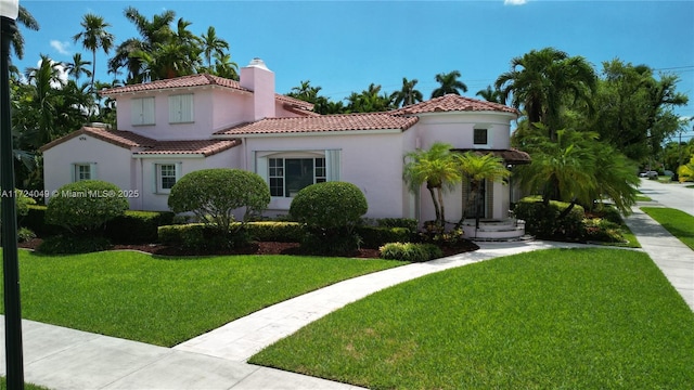 mediterranean / spanish-style house featuring a front lawn