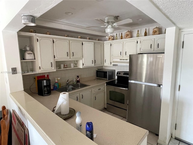 kitchen featuring backsplash, sink, white cabinets, and appliances with stainless steel finishes