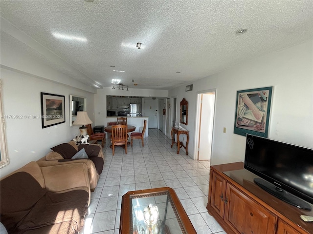 living room with light tile patterned floors and a textured ceiling