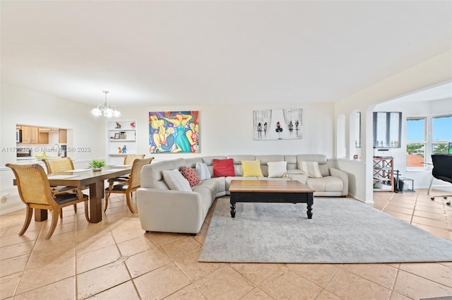 tiled living room with a chandelier