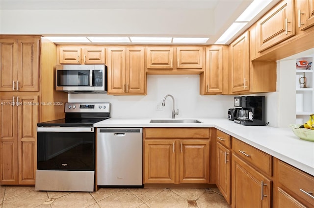 kitchen with light tile patterned floors, stainless steel appliances, and sink