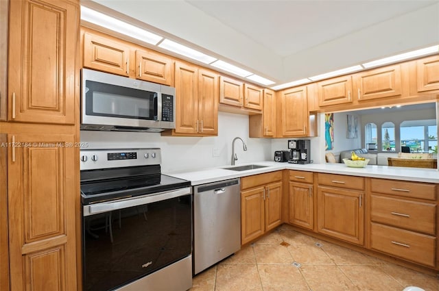 kitchen featuring sink, light tile patterned floors, and stainless steel appliances