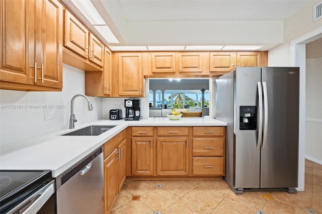 kitchen featuring sink, light tile patterned floors, and appliances with stainless steel finishes