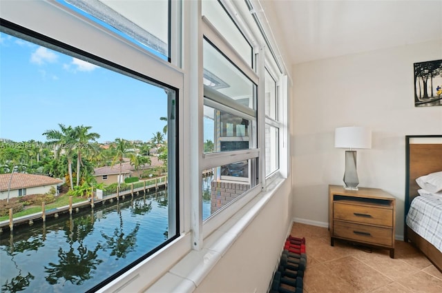 tiled bedroom featuring a water view