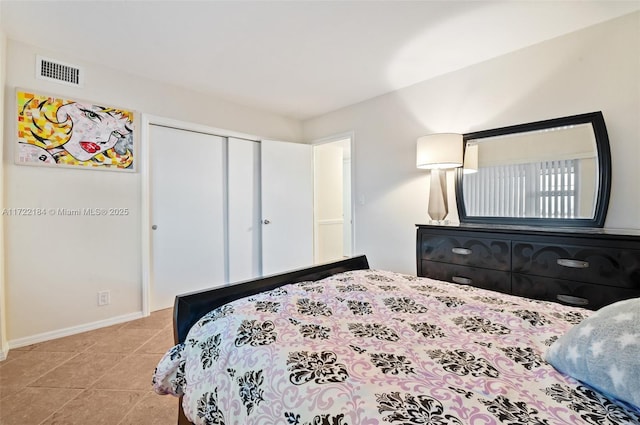 bedroom featuring light tile patterned floors and a closet