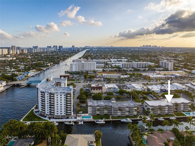 aerial view at dusk featuring a water view