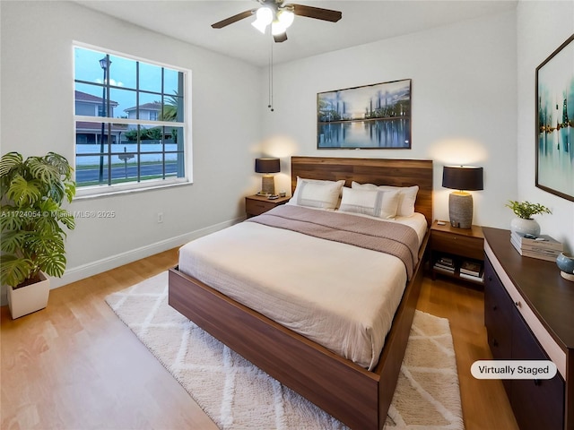 bedroom with ceiling fan and light hardwood / wood-style floors