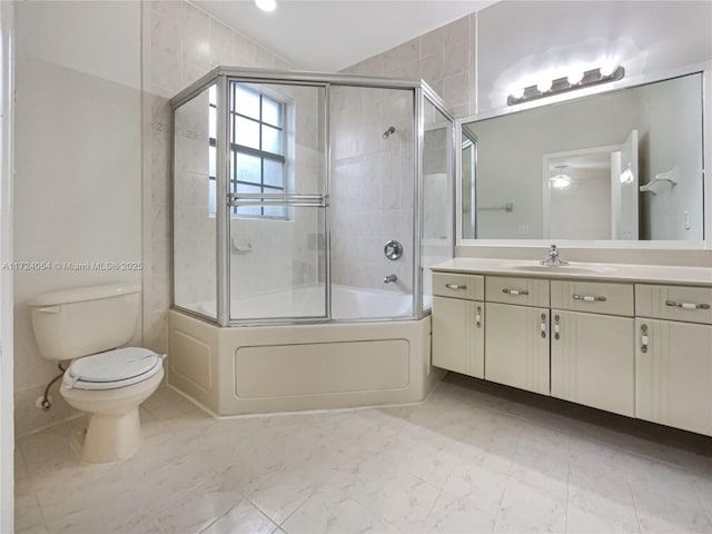 full bathroom featuring vanity, toilet, and shower / bath combination with glass door