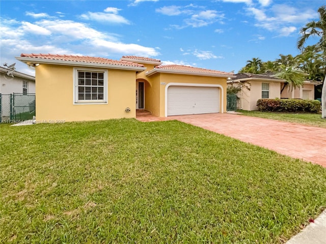 mediterranean / spanish-style home featuring a front yard and a garage