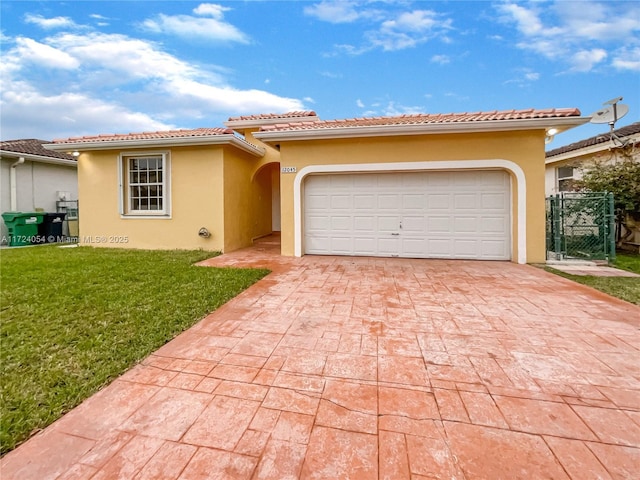 mediterranean / spanish home with a garage and a front lawn