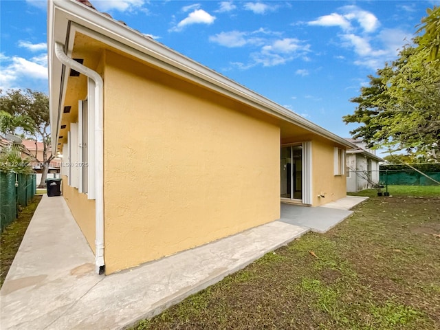 view of property exterior with a yard