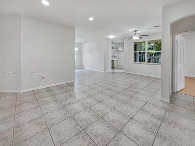 unfurnished living room featuring ceiling fan and light tile patterned flooring